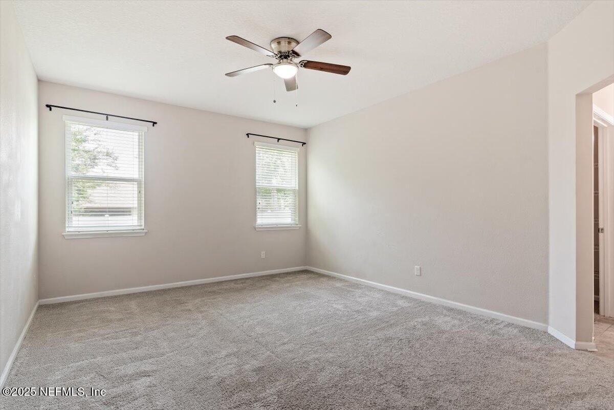 1011 Wetland Ridge Circle Middleburg, FL 32068 - Photo 25 of 73 an empty room with a window and a fan