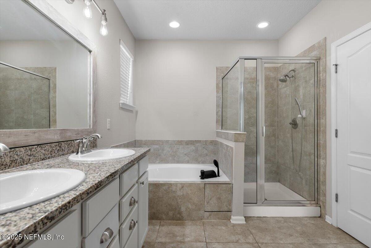 1011 Wetland Ridge Circle Middleburg, FL 32068 - Photo 28 of 73 a bathroom with a granite countertop sink and a mirror