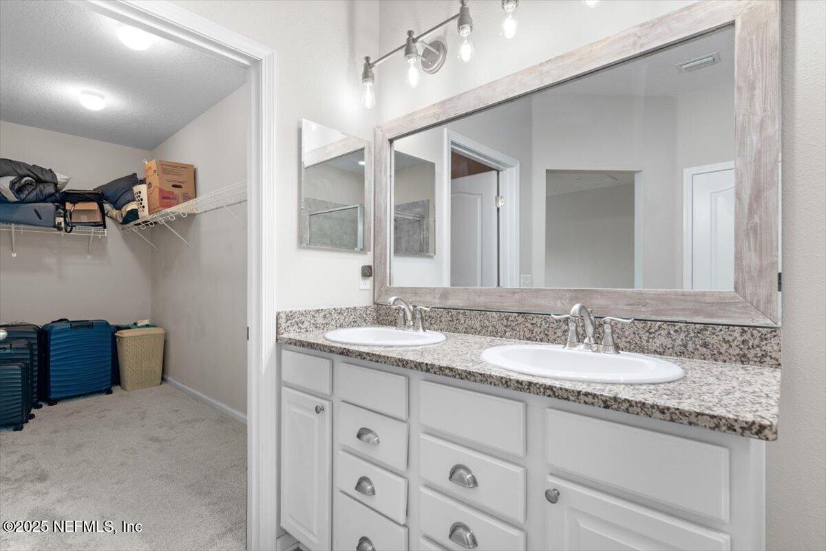 1011 Wetland Ridge Circle Middleburg, FL 32068 - Photo 29 of 73 a bathroom with a granite countertop sink mirror and double