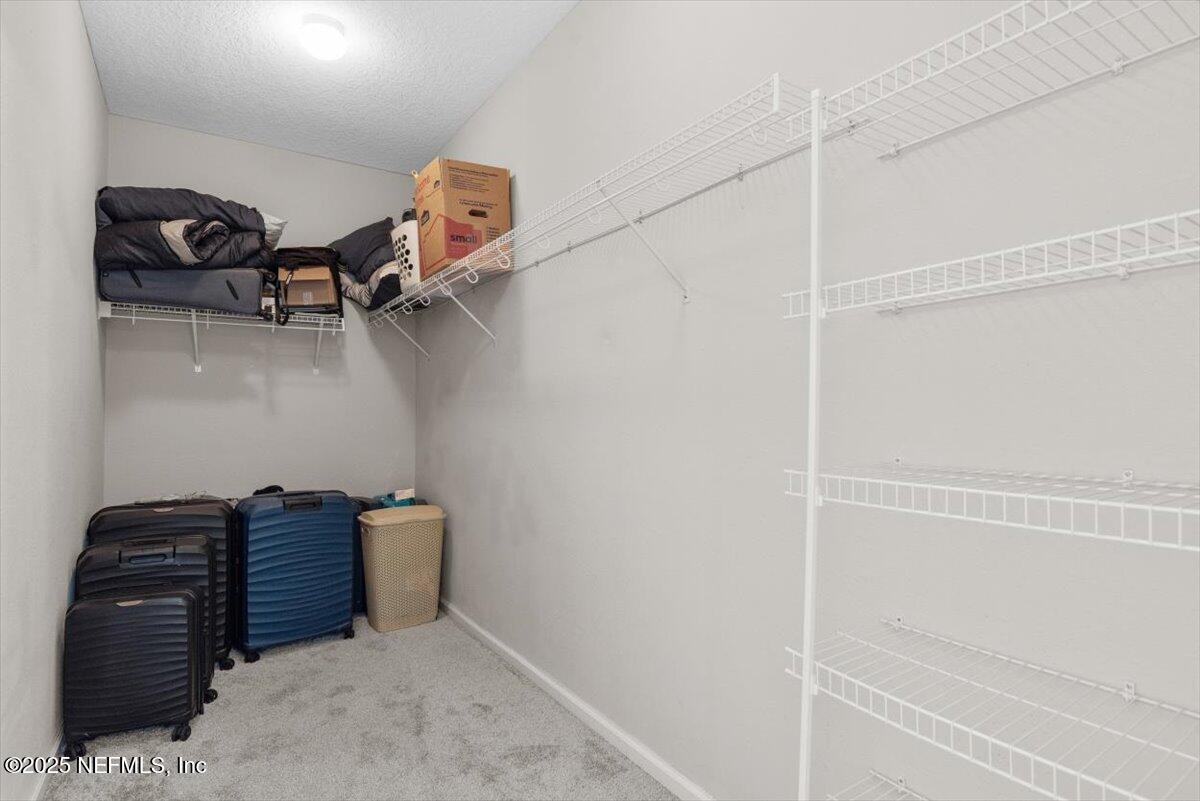 1011 Wetland Ridge Circle Middleburg, FL 32068 - Photo 30 of 73 a view of walk in closet with clothes and shoes