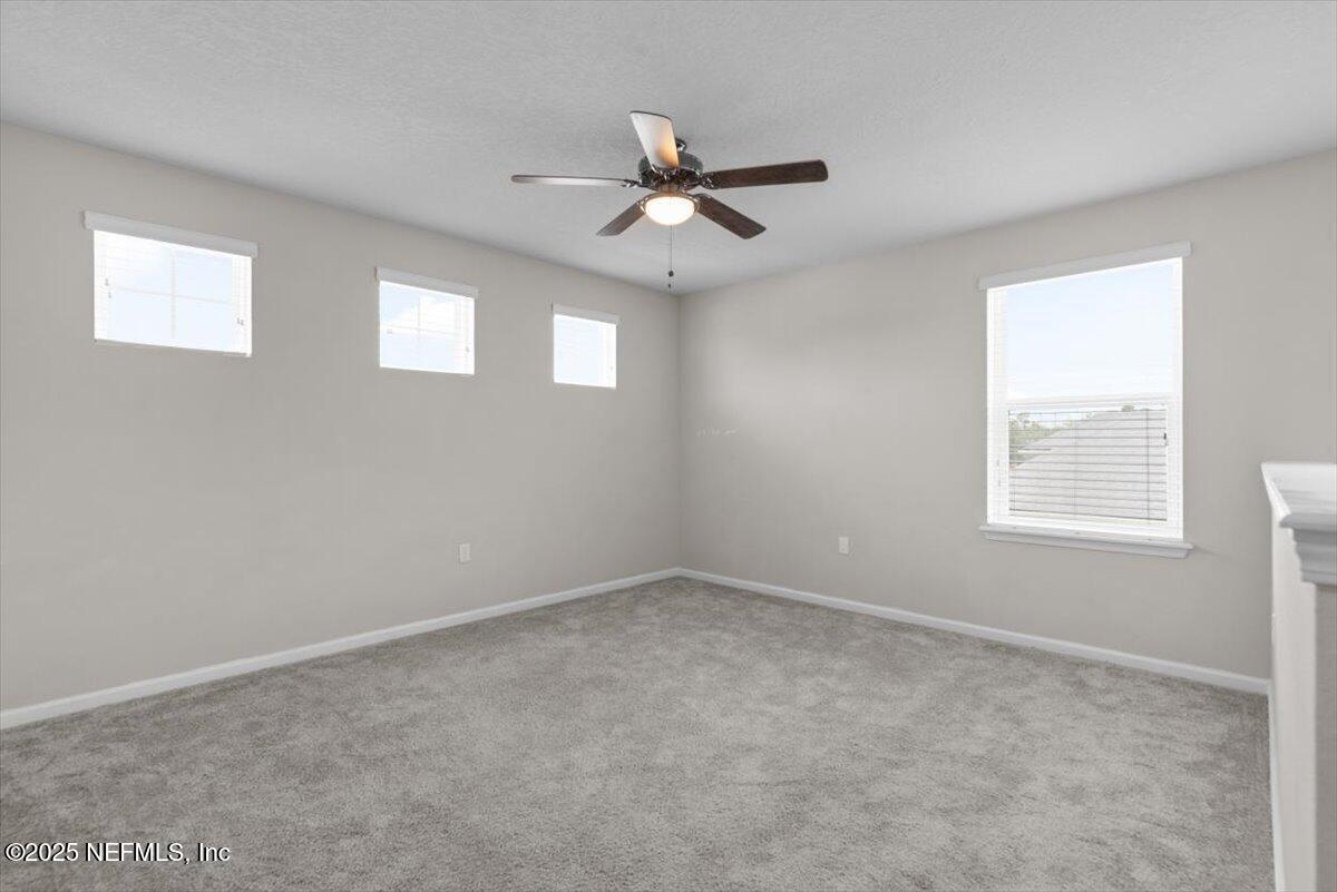 1011 Wetland Ridge Circle Middleburg, FL 32068 - Photo 37 of 73 an empty room with windows and fan