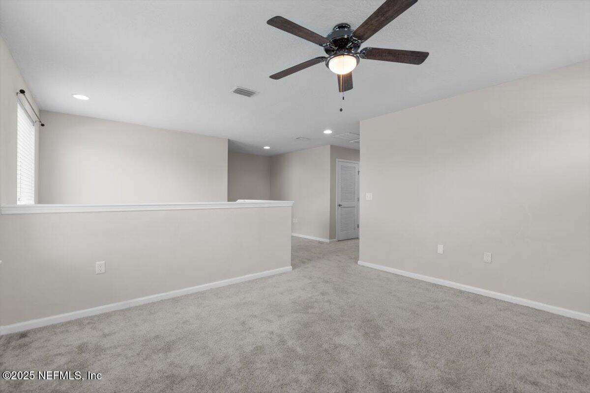 1011 Wetland Ridge Circle Middleburg, FL 32068 - Photo 38 of 73 en empty room with ceiling fan and window