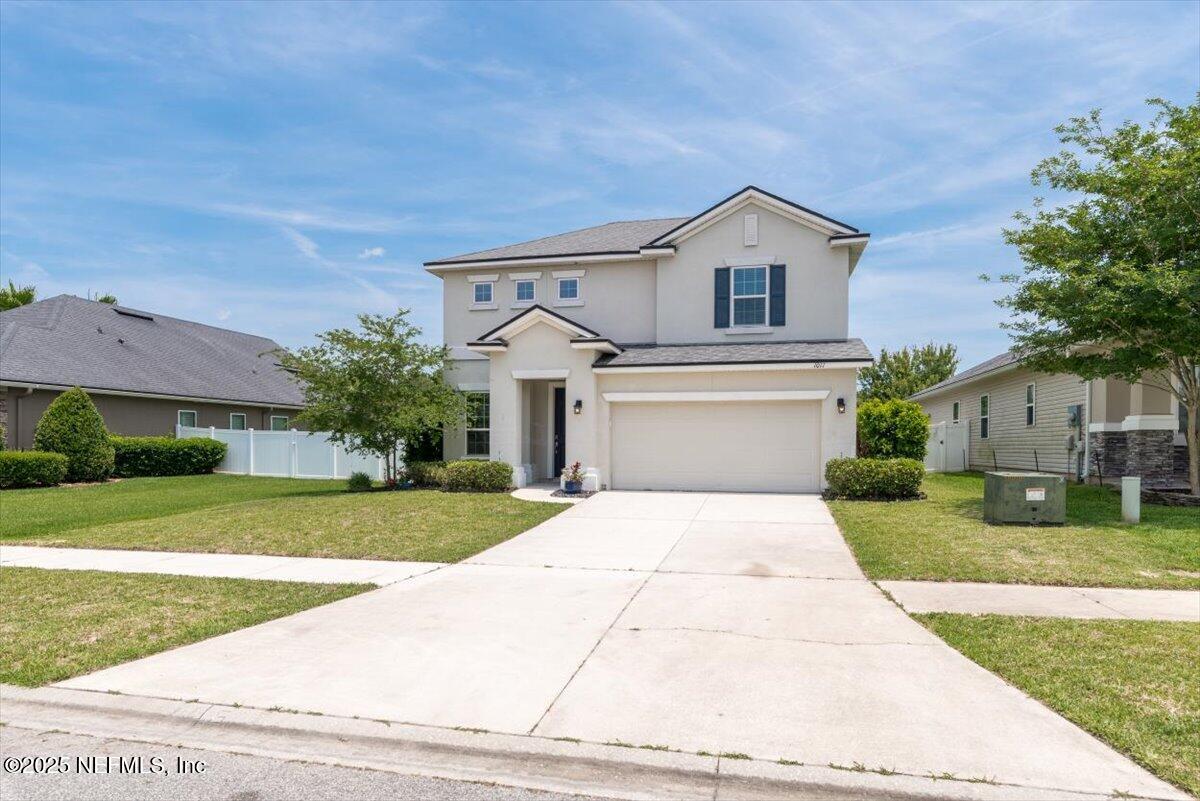 1011 Wetland Ridge Circle Middleburg, FL 32068 - Photo 4 of 73 a front view of a house with a yard and garage