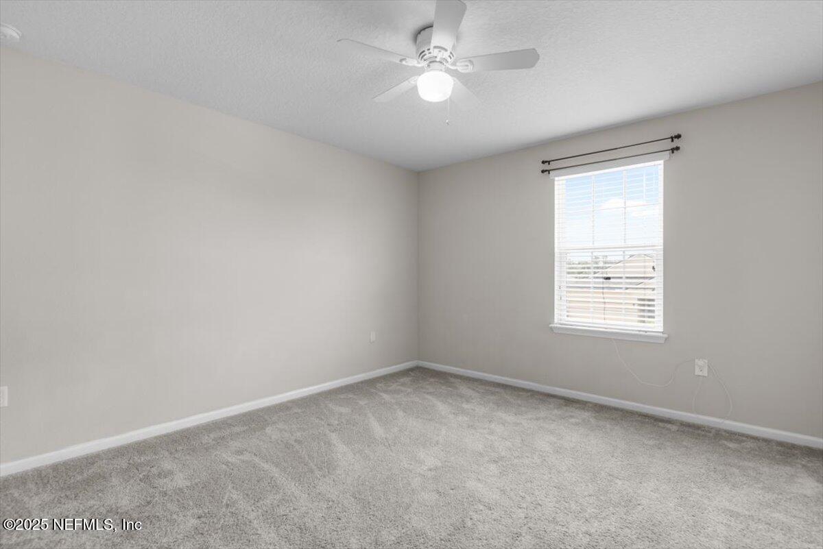 1011 Wetland Ridge Circle Middleburg, FL 32068 - Photo 40 of 73 an empty room with a window and ceiling fan