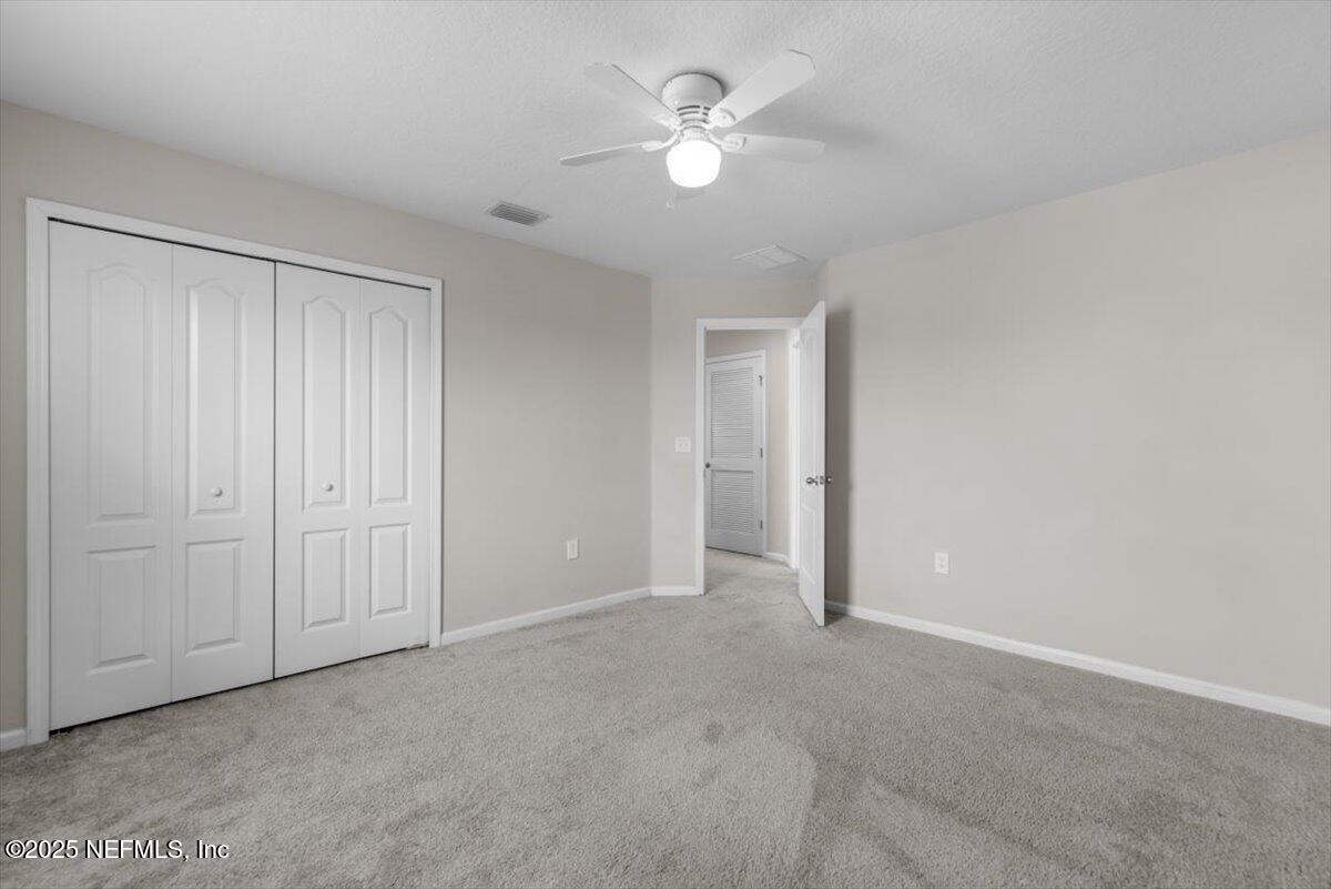 1011 Wetland Ridge Circle Middleburg, FL 32068 - Photo 41 of 73 an empty room with closet and a ceiling fan