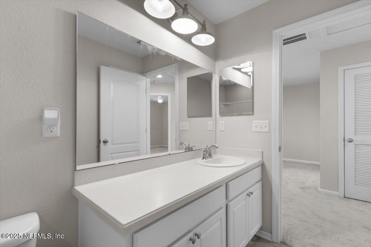 1011 Wetland Ridge Circle Middleburg, FL 32068 - Photo 43 of 73 a bathroom with a sink vanity and a mirror