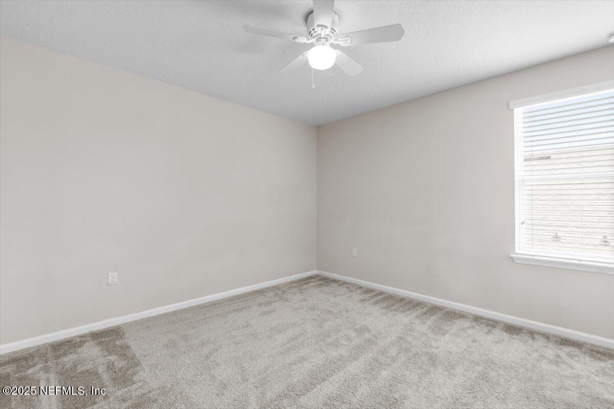 1011 Wetland Ridge Circle Middleburg, FL 32068 - Photo 44 of 73 an empty room with a window and ceiling fan