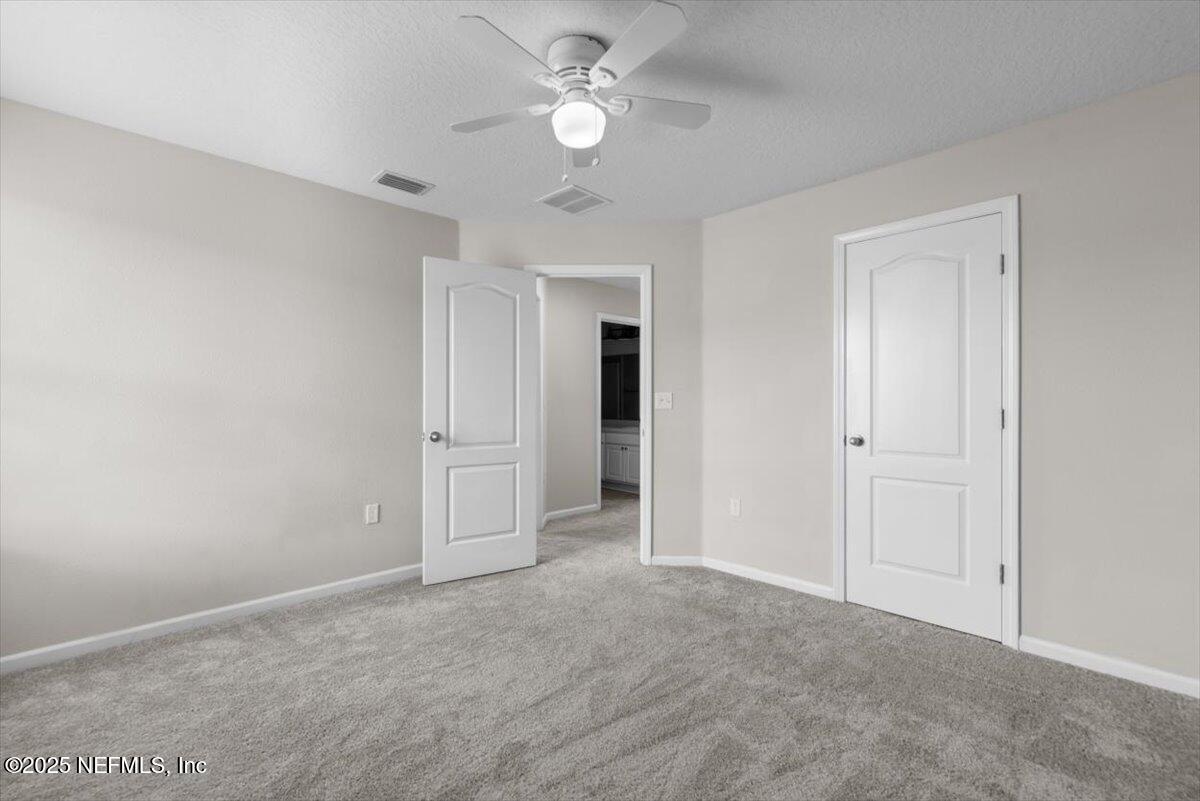 1011 Wetland Ridge Circle Middleburg, FL 32068 - Photo 45 of 73 a view of an empty room and a ceiling fan & windows