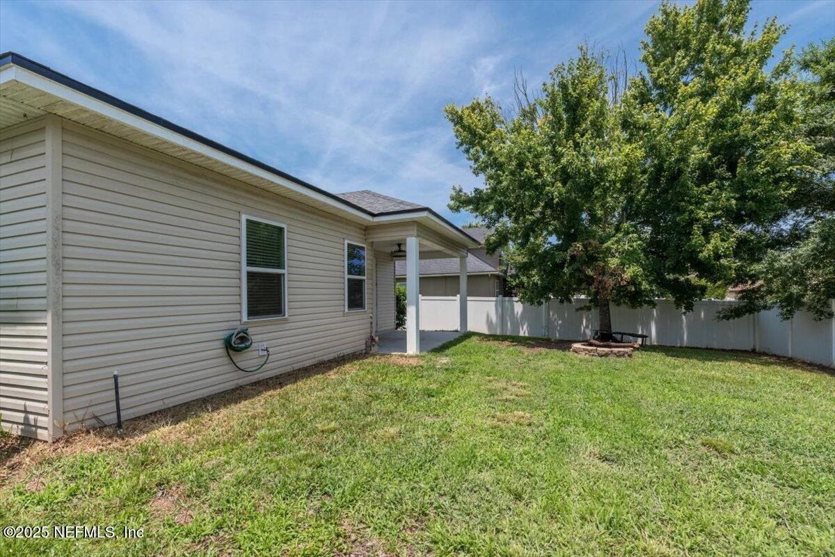 1011 Wetland Ridge Circle Middleburg, FL 32068 - Photo 52 of 73 a backyard of a house with seating and yard