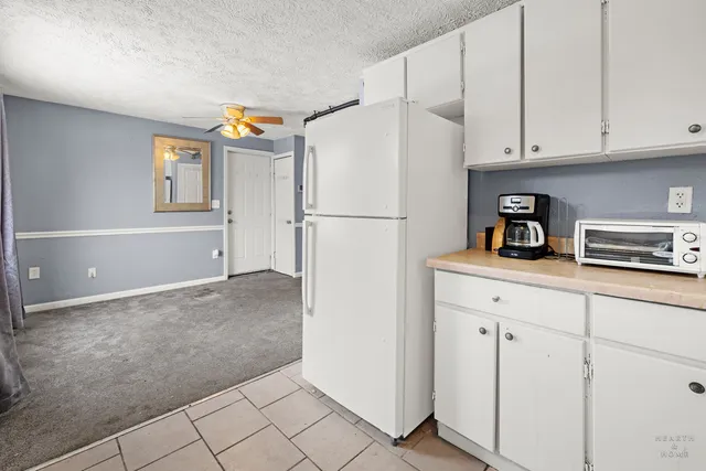 a white refrigerator freezer sitting in a kitchen