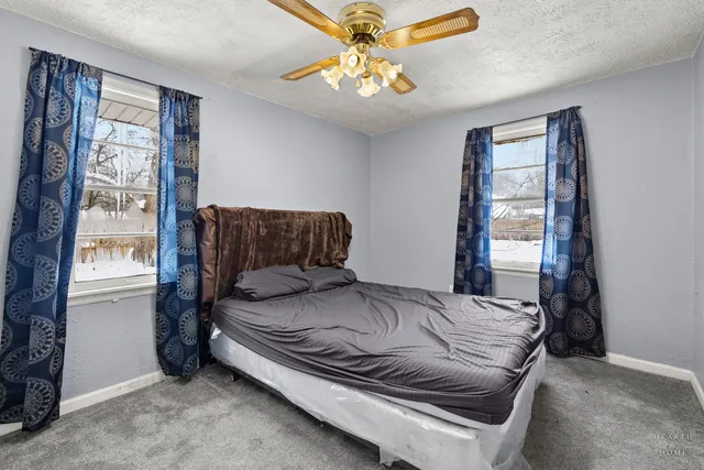 a bed sitting in a bedroom next to a window