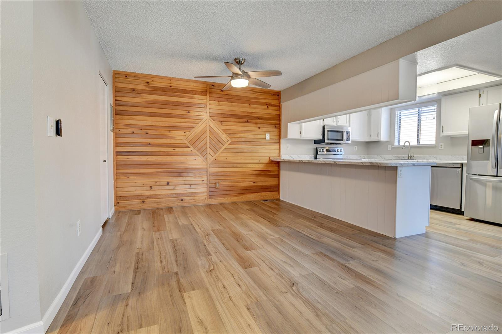 9501 West 89th Circle Broomfield, CO 80021 - Photo 11 of 33 a view of kitchen with wooden floor and electronic appliances