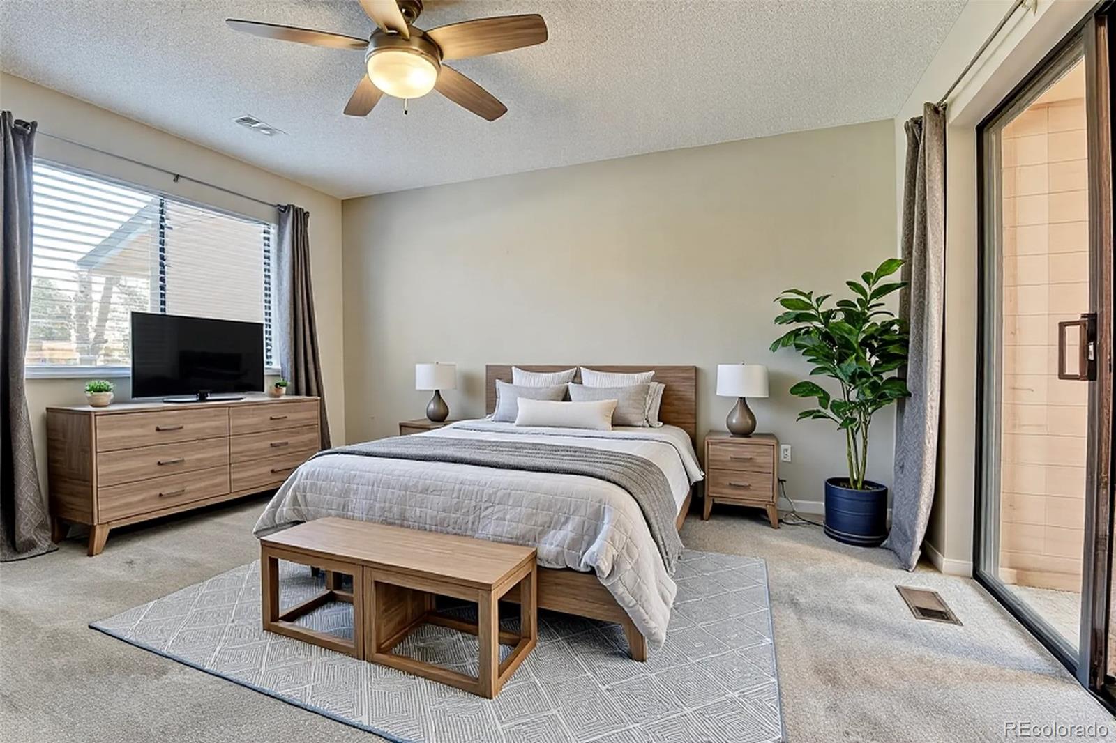 9501 West 89th Circle Broomfield, CO 80021 - Photo 12 of 33 a bedroom with a bed and a flat screen tv