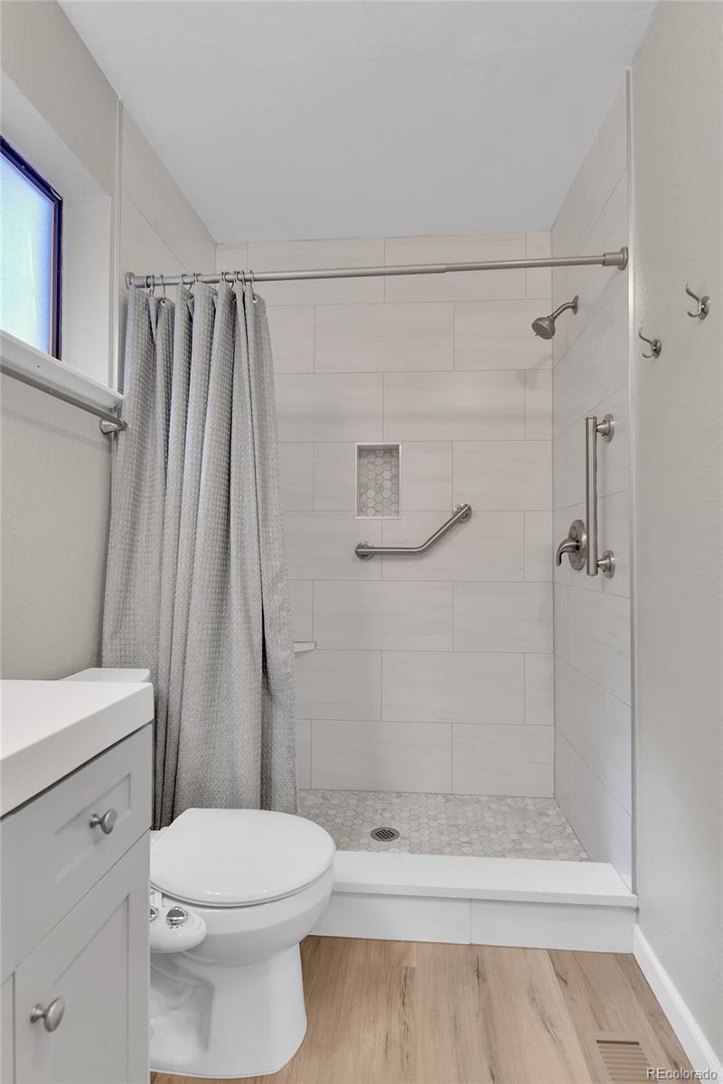 9501 West 89th Circle Broomfield, CO 80021 - Photo 17 of 33 a bathroom with a shower a toilet and a shower