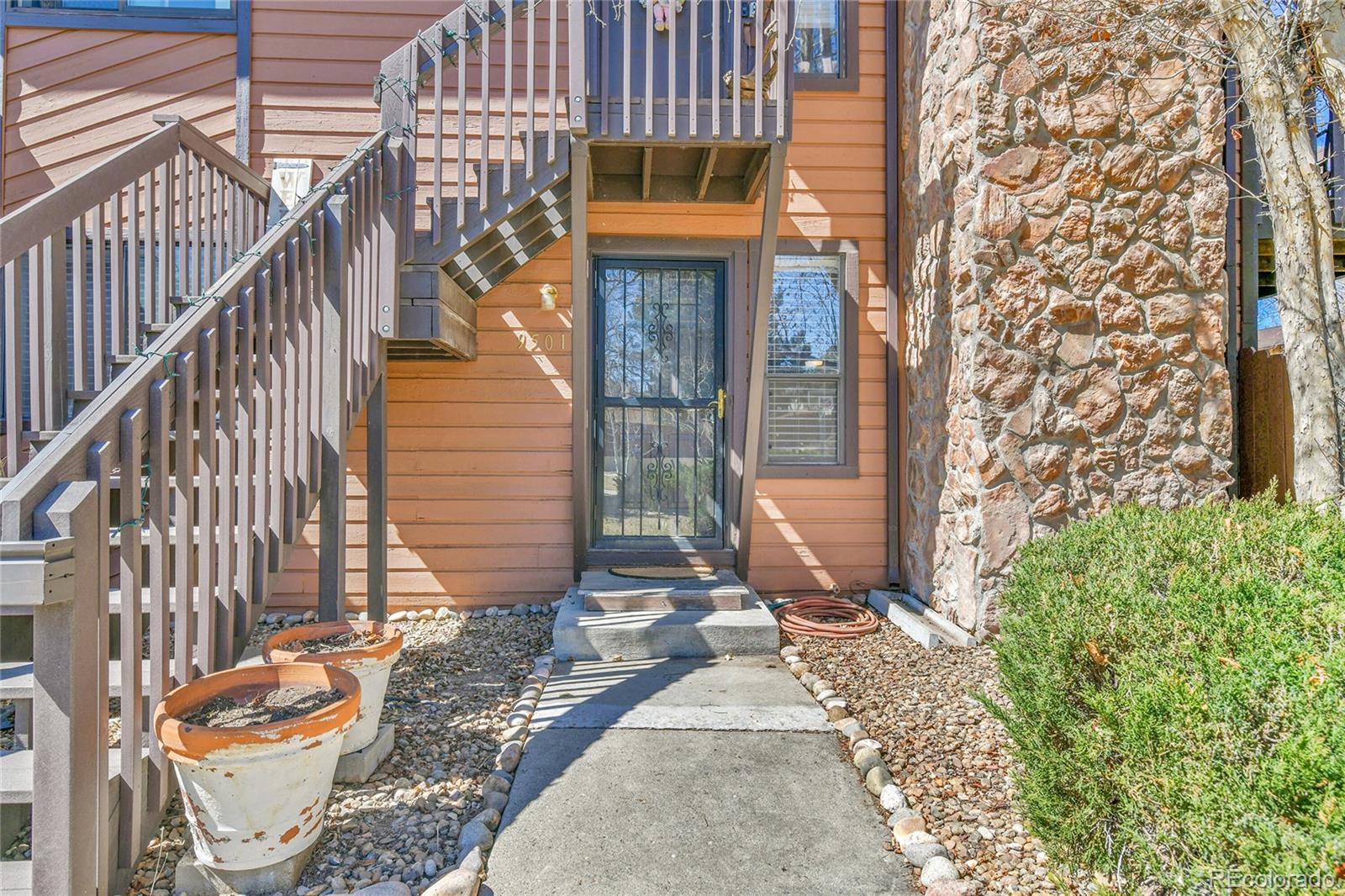 9501 West 89th Circle Broomfield, CO 80021 - Photo 19 of 33 a view of a brick house with many windows