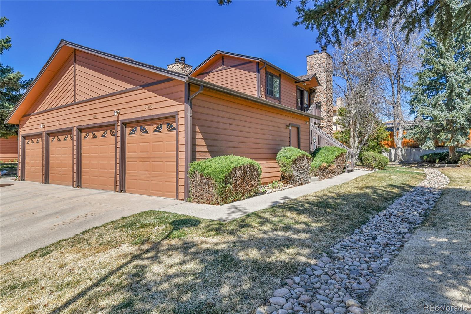 9501 West 89th Circle Broomfield, CO 80021 - Photo 20 of 33 a front view of a house with garden