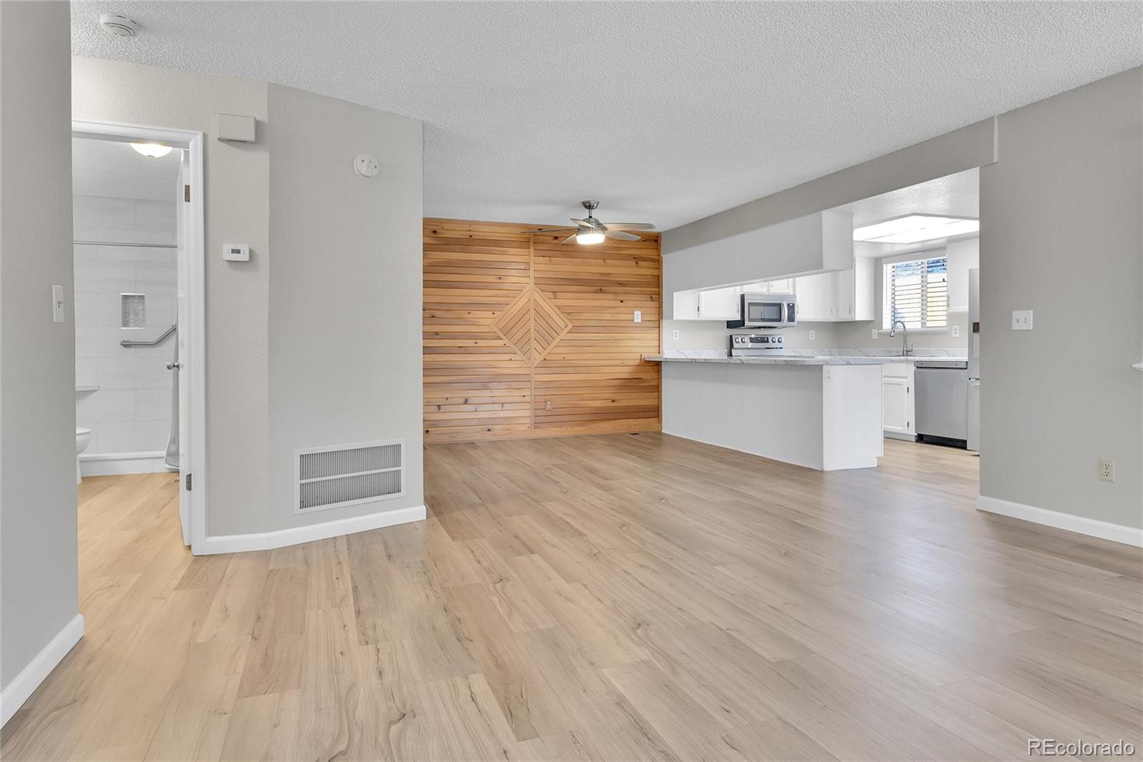 9501 West 89th Circle Broomfield, CO 80021 - Photo 2 of 33 a view of kitchen with wooden floor and electronic appliances