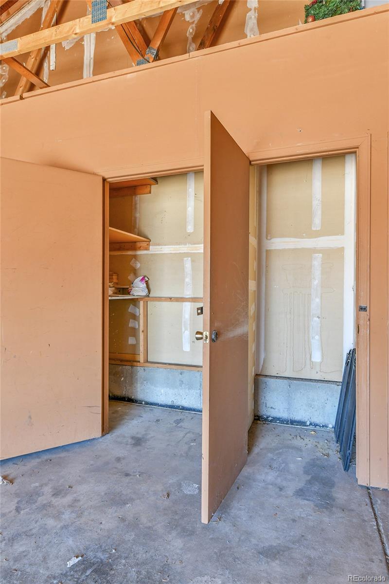 9501 West 89th Circle Broomfield, CO 80021 - Photo 23 of 33 a view of a room with wooden shelves