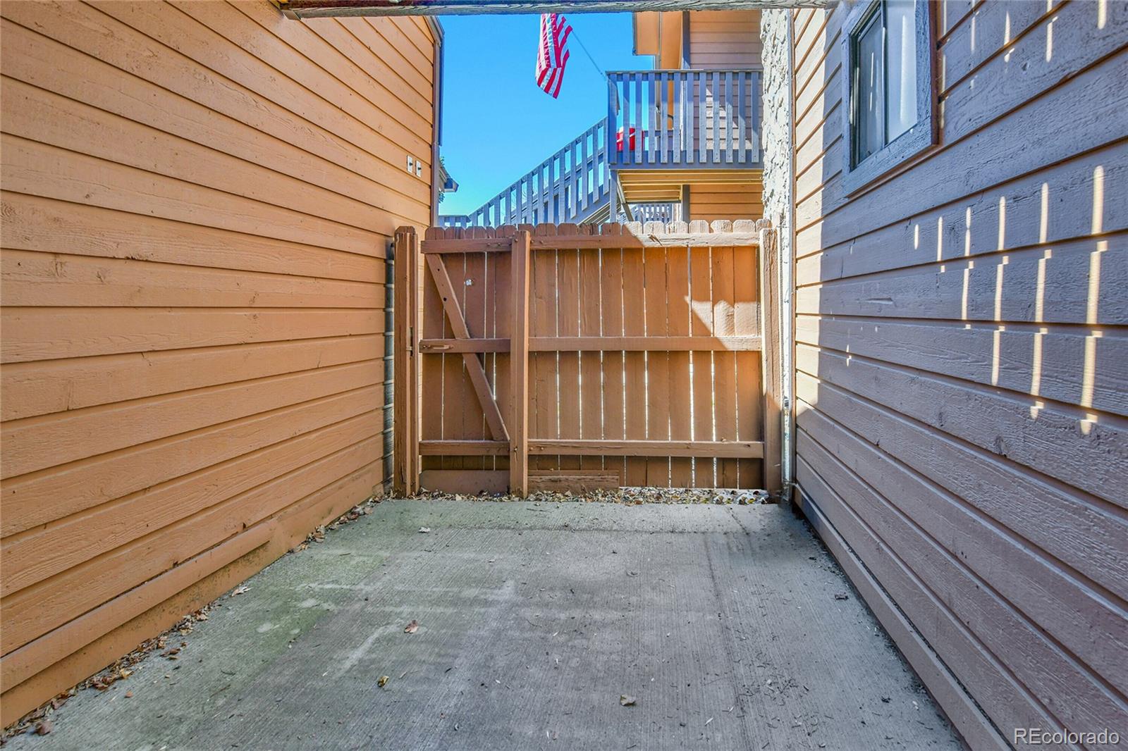 9501 West 89th Circle Broomfield, CO 80021 - Photo 25 of 33 a view of a house with a wooden fence