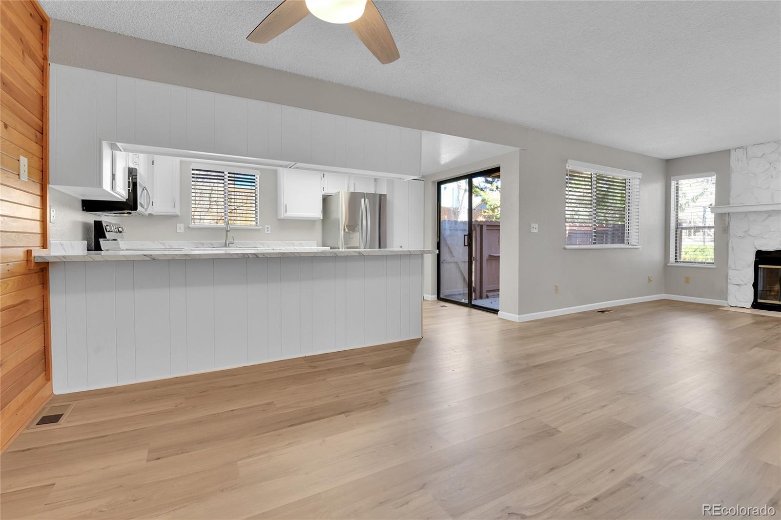 9501 West 89th Circle Broomfield, CO 80021 - Photo 5 of 33 an empty room with wooden floor and windows