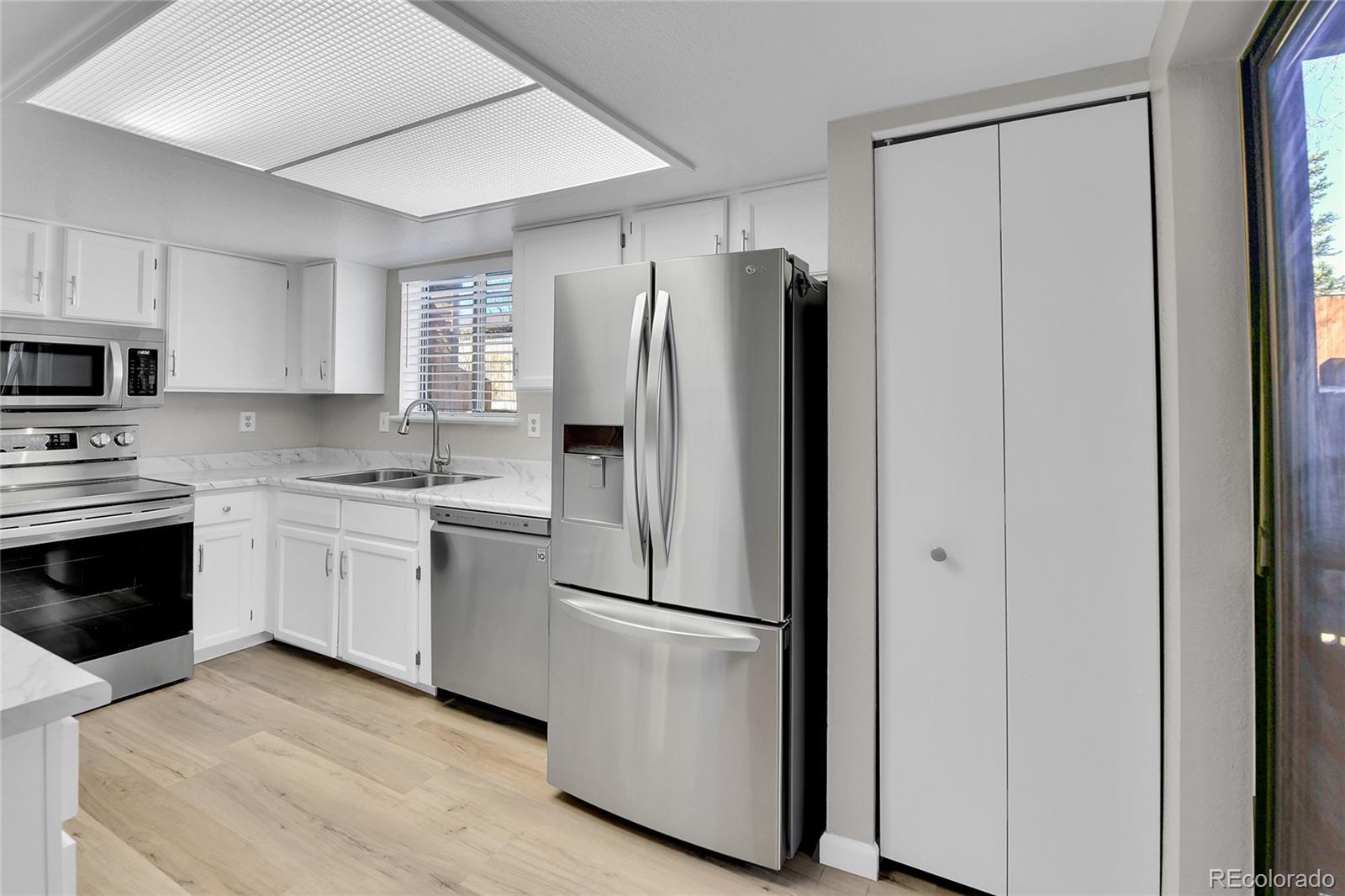 9501 West 89th Circle Broomfield, CO 80021 - Photo 7 of 33 a kitchen with a refrigerator sink and microwave