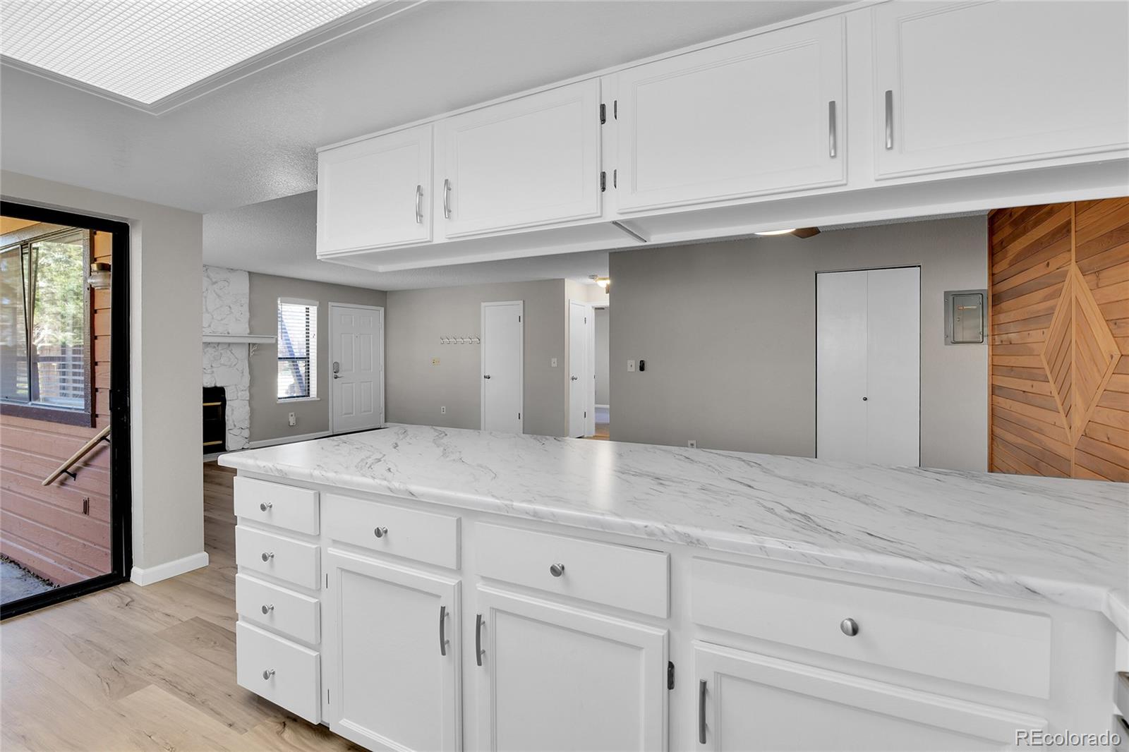 9501 West 89th Circle Broomfield, CO 80021 - Photo 9 of 33 a kitchen with white cabinets and a sink