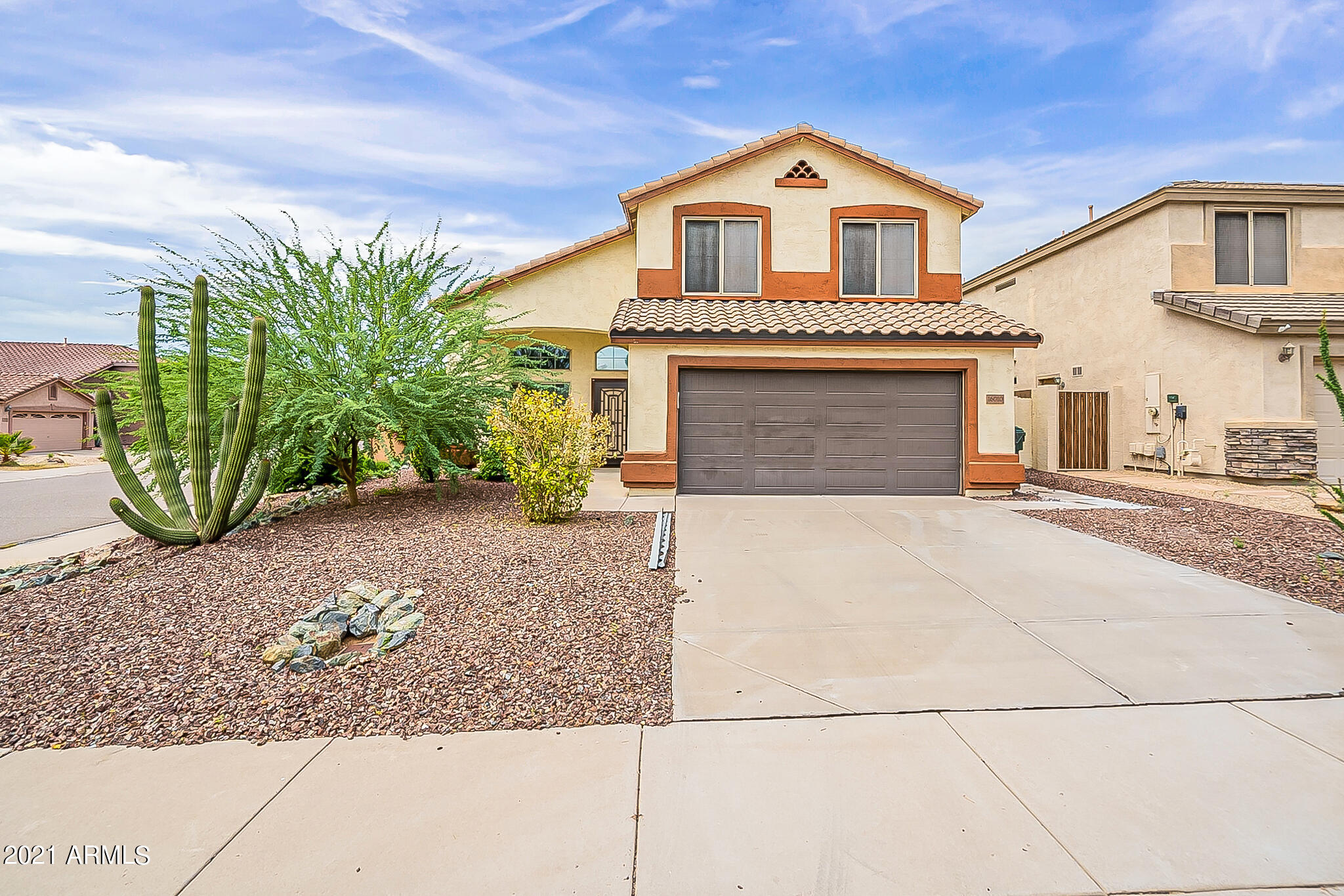 a front view of a house with garden