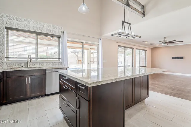 a kitchen with stainless steel appliances granite countertop a stove and a sink