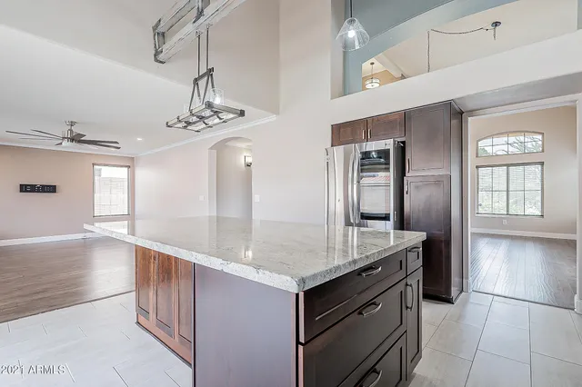 a bathroom with a granite countertop sink a large mirror and a shower