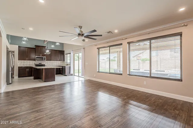 a view of an empty room with kitchen appliances and a window