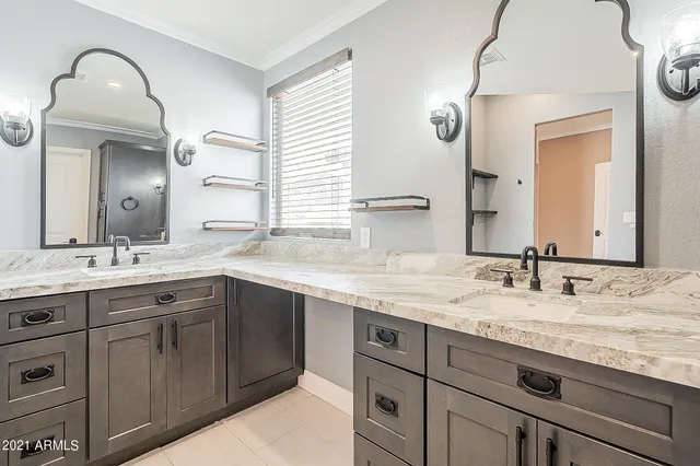 a bathroom with a granite countertop sink double and mirror