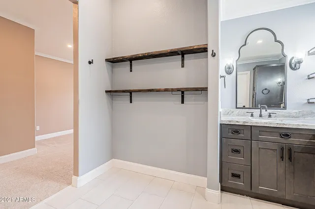 a bathroom with a granite countertop sink mirror and vanity