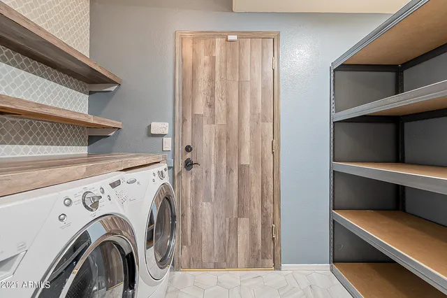 a view of storage and utility room with washer and dryer