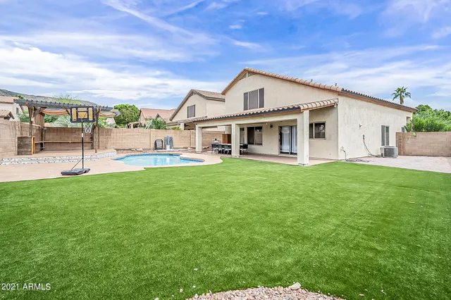 a front view of a house with a yard table and chairs