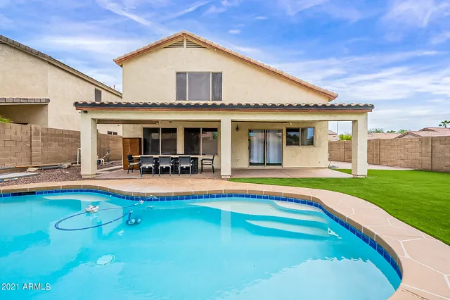 a view of a house with swimming pool yard and patio