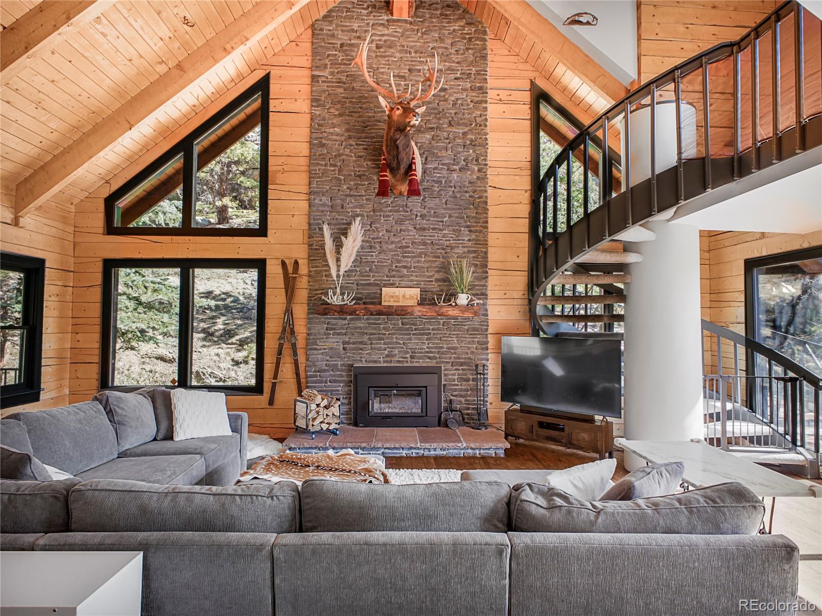 24 Pine Valley Road Evergreen, CO 80439 - Photo 5 of 50 a living room with fireplace furniture and a floor to ceiling window