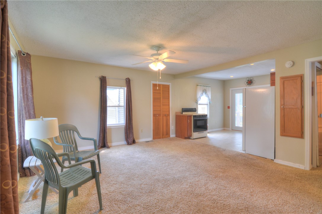 63 Grays Lane Decatur, IL 62526 - Photo 7 of 28 a view of a livingroom with furniture and a ceiling fan