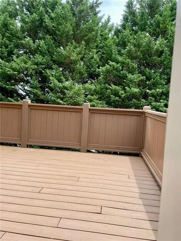 a view of empty room with wooden floor and fireplace