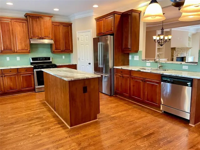 a bathroom with a tub shower sink and mirror