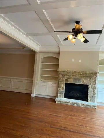 a view of a room with wooden floor and chandelier