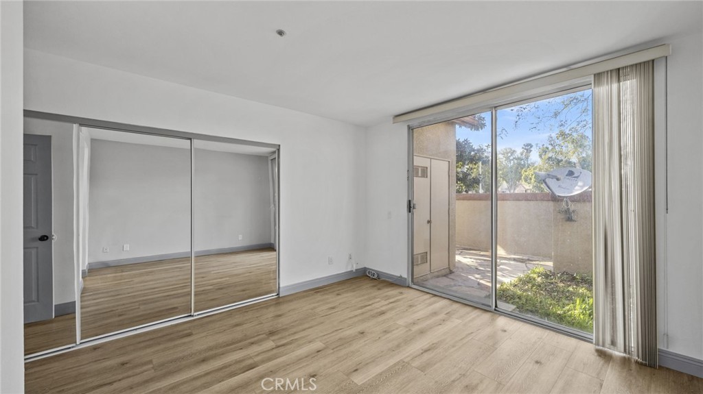 2901 Vía Toscana, Unit 101 Corona, CA 92879 - Photo 15 of 28 wooden floor in an empty room with a window