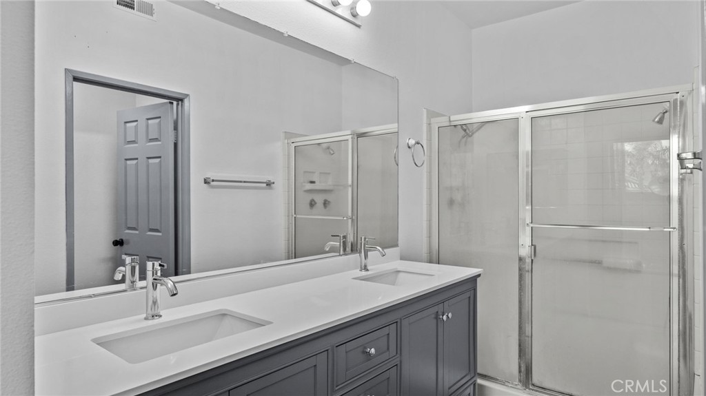 2901 Vía Toscana, Unit 101 Corona, CA 92879 - Photo 16 of 28 a bathroom with a granite countertop sink mirror and double