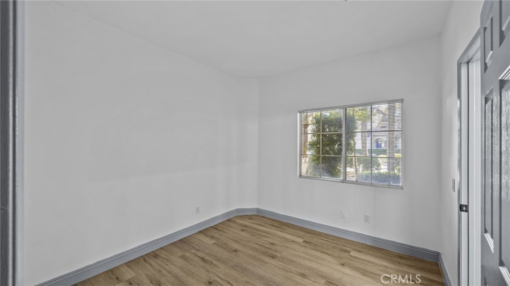 2901 Vía Toscana, Unit 101 Corona, CA 92879 - Photo 17 of 28 a view of an empty room with wooden floor and a window