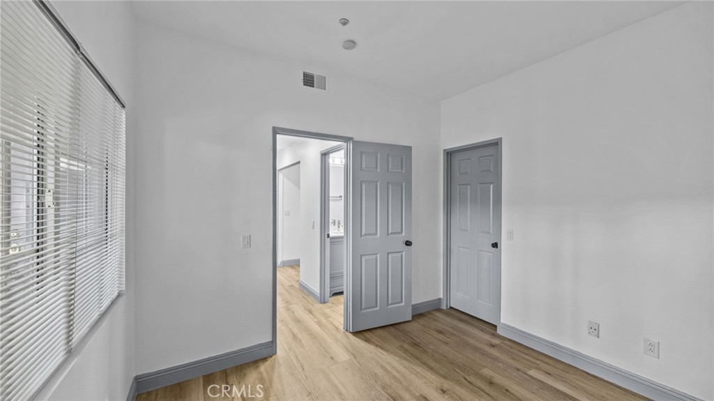 2901 Vía Toscana, Unit 101 Corona, CA 92879 - Photo 18 of 28 a view of an empty room with wooden floor and a window