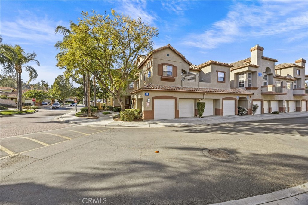 2901 Vía Toscana, Unit 101 Corona, CA 92879 - Photo 2 of 28 a front view of a residential houses with yard