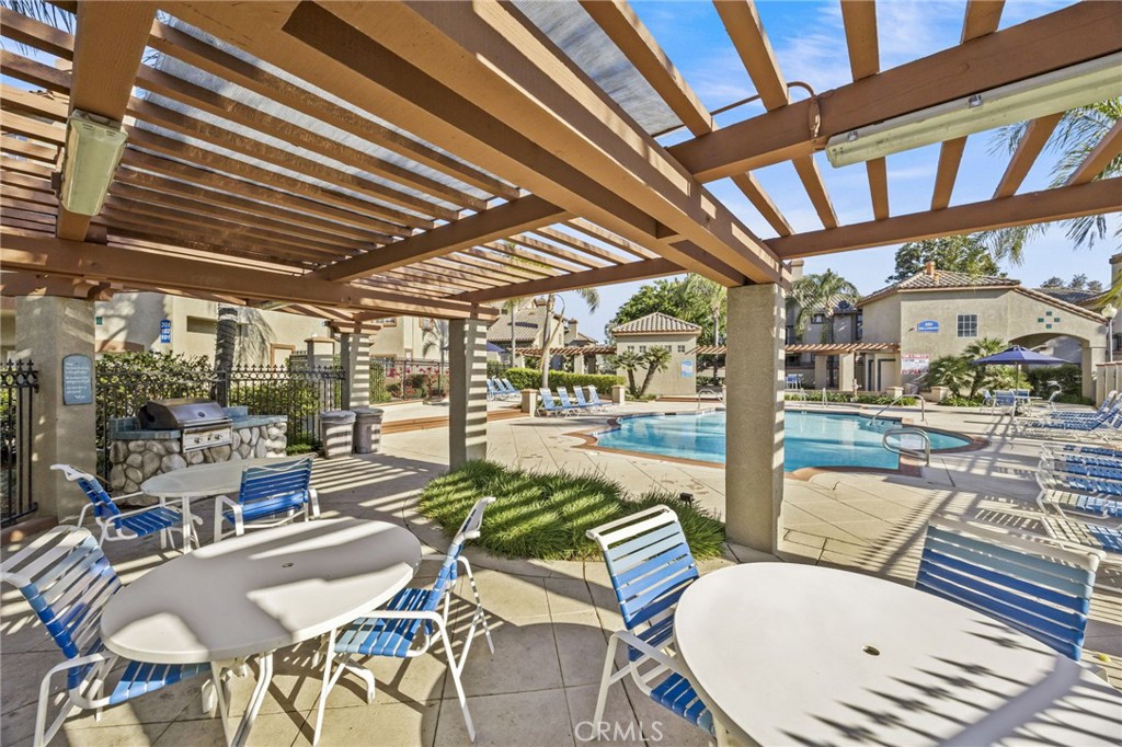 2901 Vía Toscana, Unit 101 Corona, CA 92879 - Photo 25 of 28 a building outdoor space with patio furniture