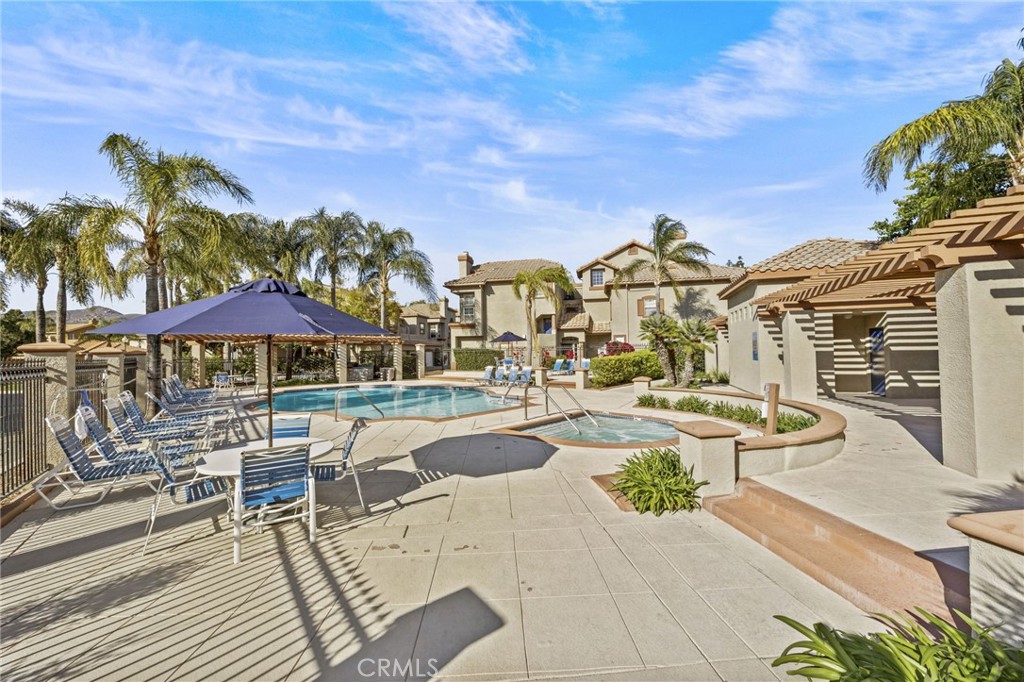 2901 Vía Toscana, Unit 101 Corona, CA 92879 - Photo 26 of 28 a view of a swimming pool with outdoor seating