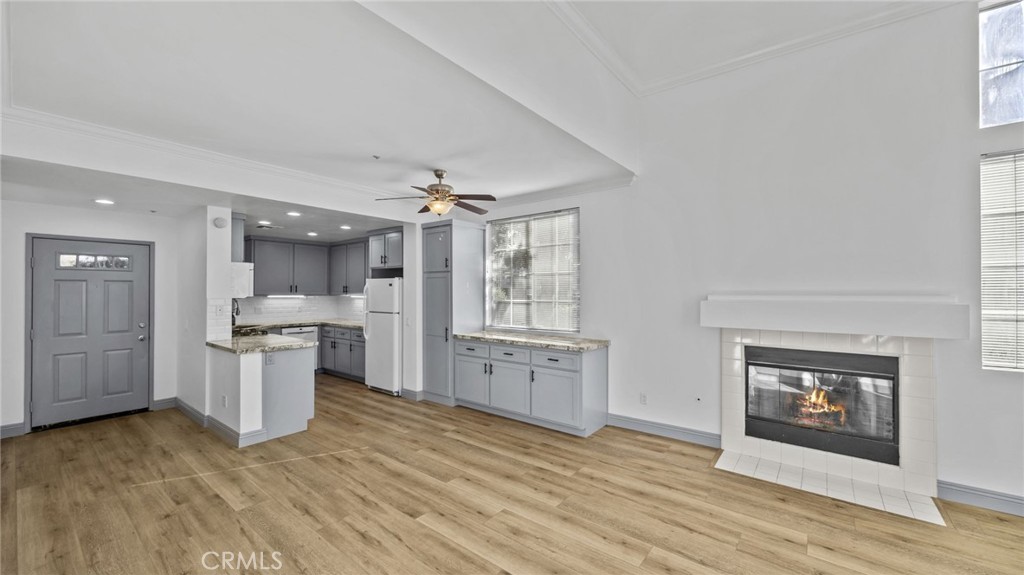 2901 Vía Toscana, Unit 101 Corona, CA 92879 - Photo 5 of 28 a large kitchen with a wooden floor and a stove top oven