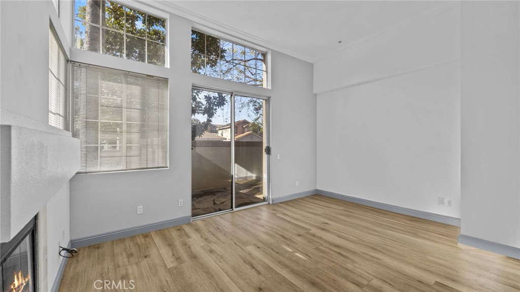 2901 Vía Toscana, Unit 101 Corona, CA 92879 - Photo 9 of 28 an empty room with wooden floor and windows
