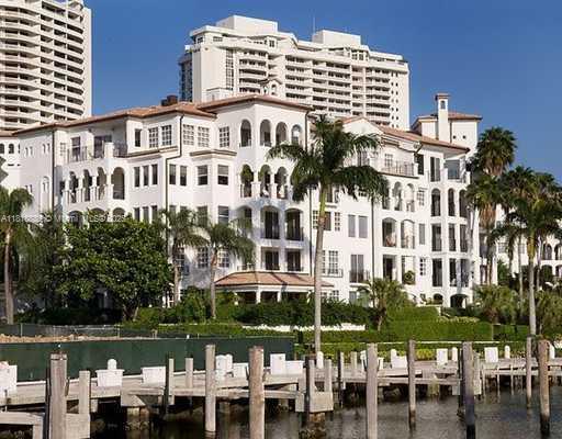 a front view of a building with lake view and a big yard